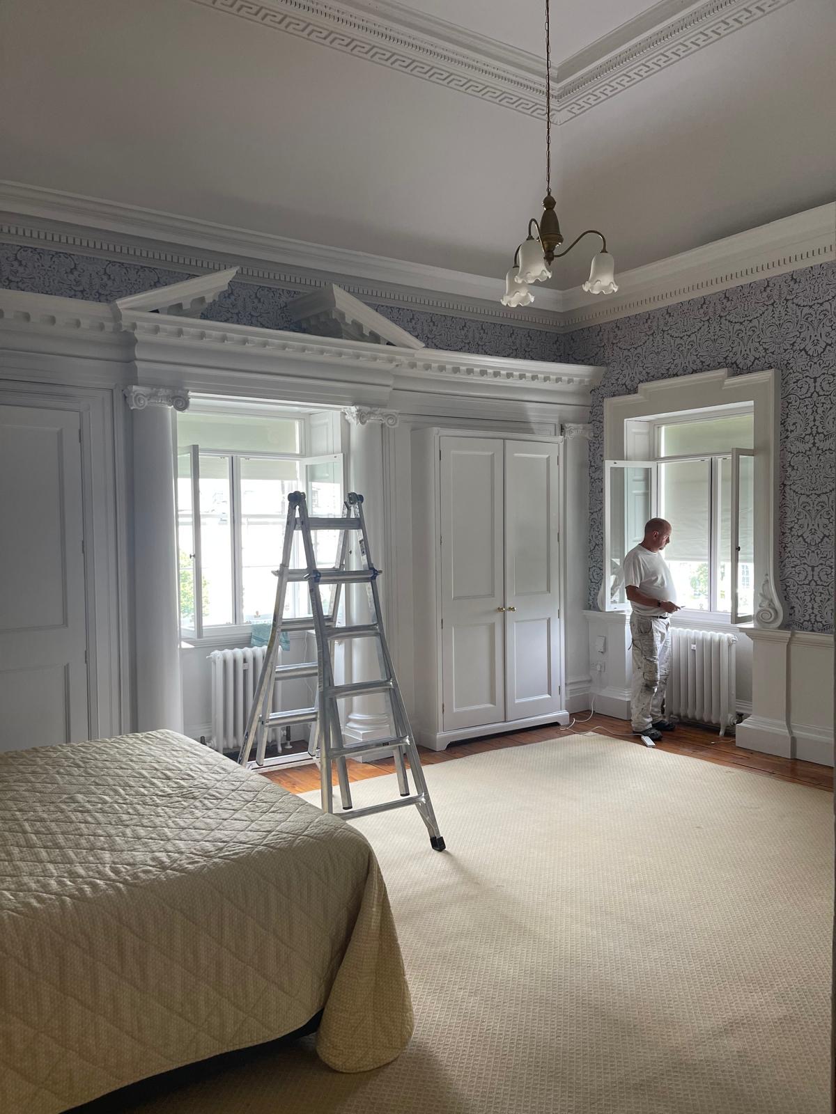 Bayassi Contractors painter working on a detailed interior